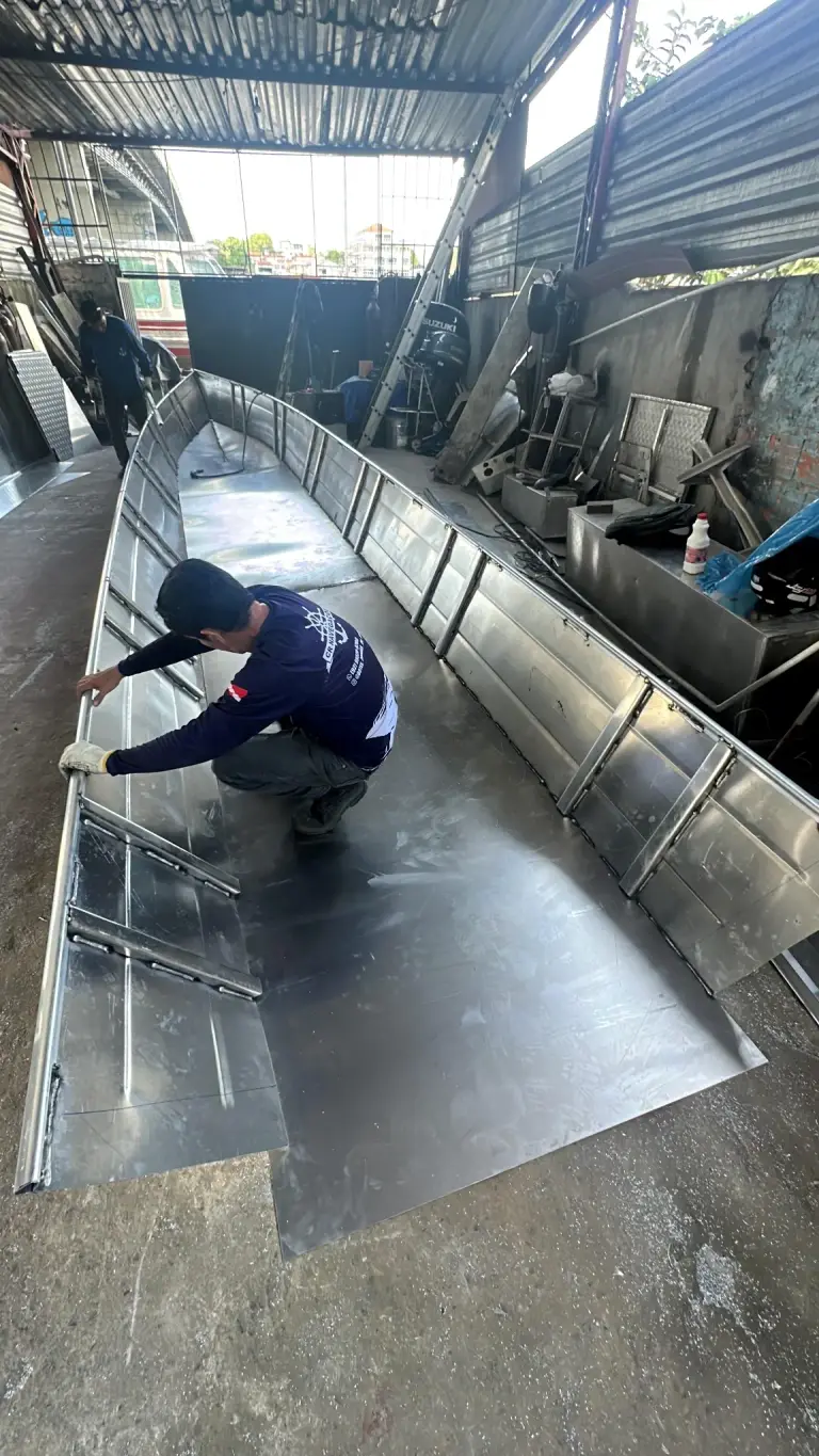 Trabalhador ajustando estrutura interna de alumínio